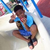 boy enjoying his afterschool meals on the playground