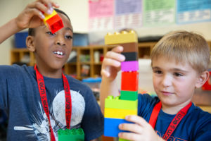 students working together to build a Lego tower