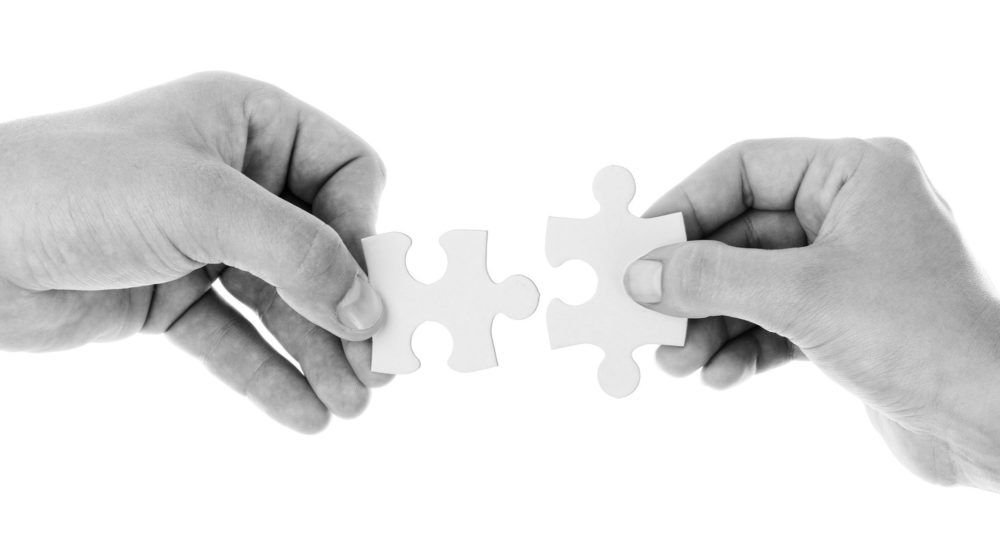 2 hands connect puzzle pieces