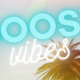 BOOST vibes glowing text over palm tree background