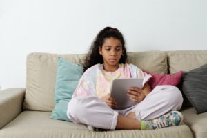 teen using tablet to read stories