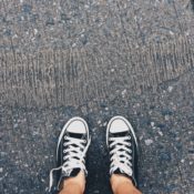 Converse sneakers standing on asphalt