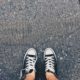 Converse sneakers standing on asphalt