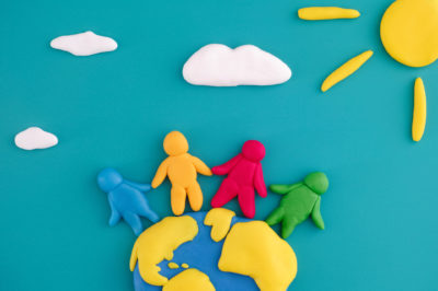 Group of people around the world. Scene is made out of polymer clay.