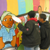 2 youth paint a mural
