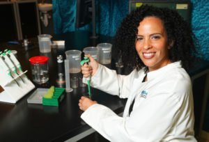 women in STEM work in a lab conducting research