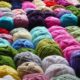 rolls of wool yarn for knitting in a rainbow of colors