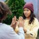 two adolescent girls giving high fives