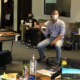 man in mask leading staff meeting