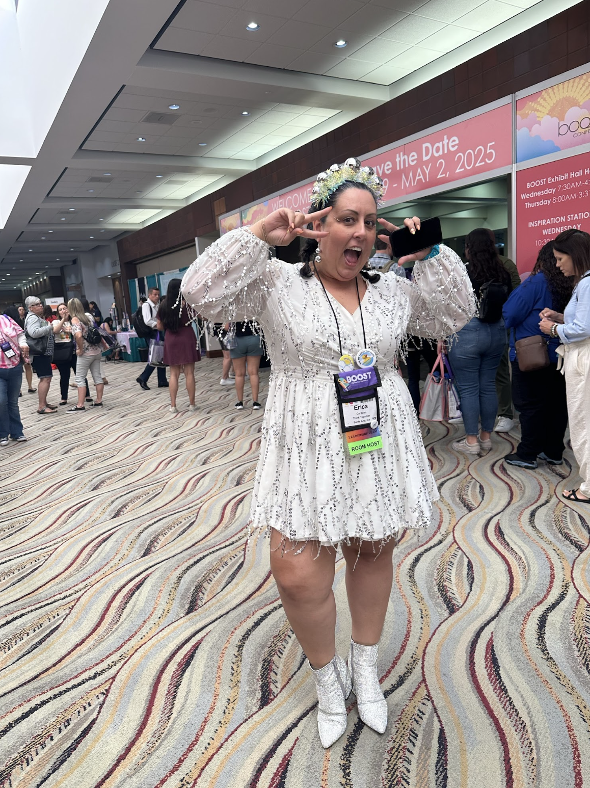 A photo of Erica at BOOST Conference wearing a white dress.