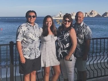 Picture of Lilly and her husband, son, and daughter in front of the water.