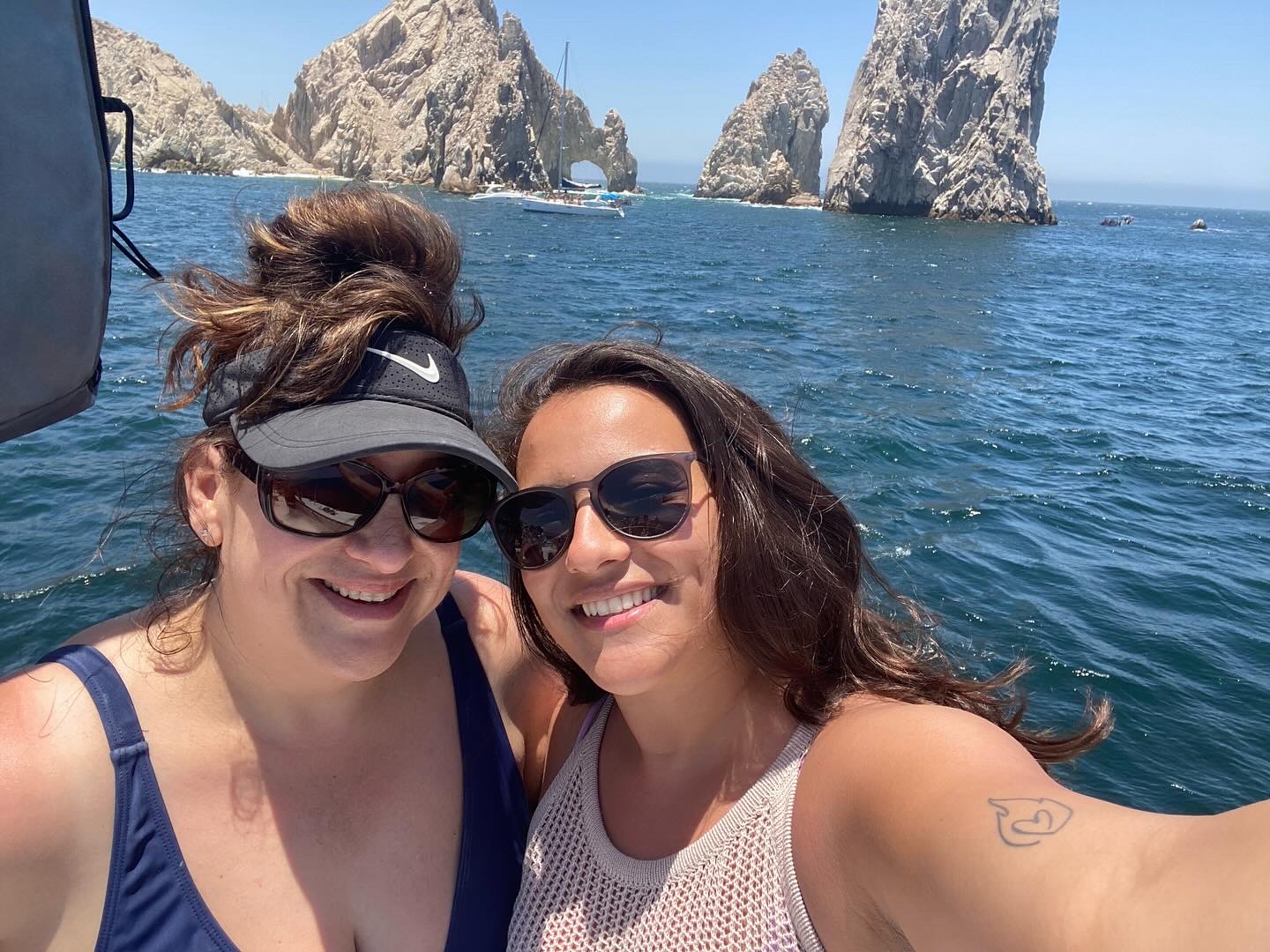 A picture of Lilly and her daughter with the water and stone in the background.