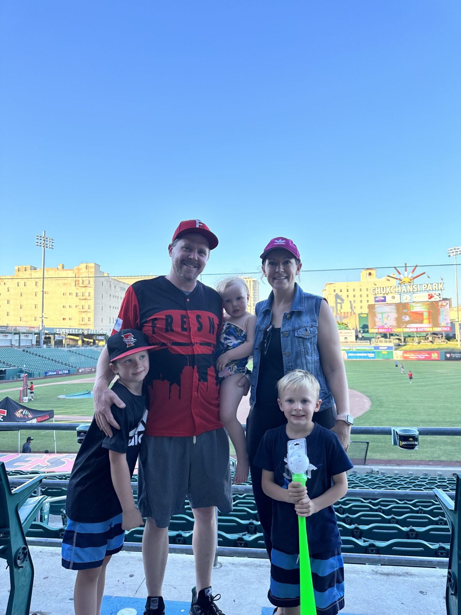 A photo of Andrea and her family at a baseball game.