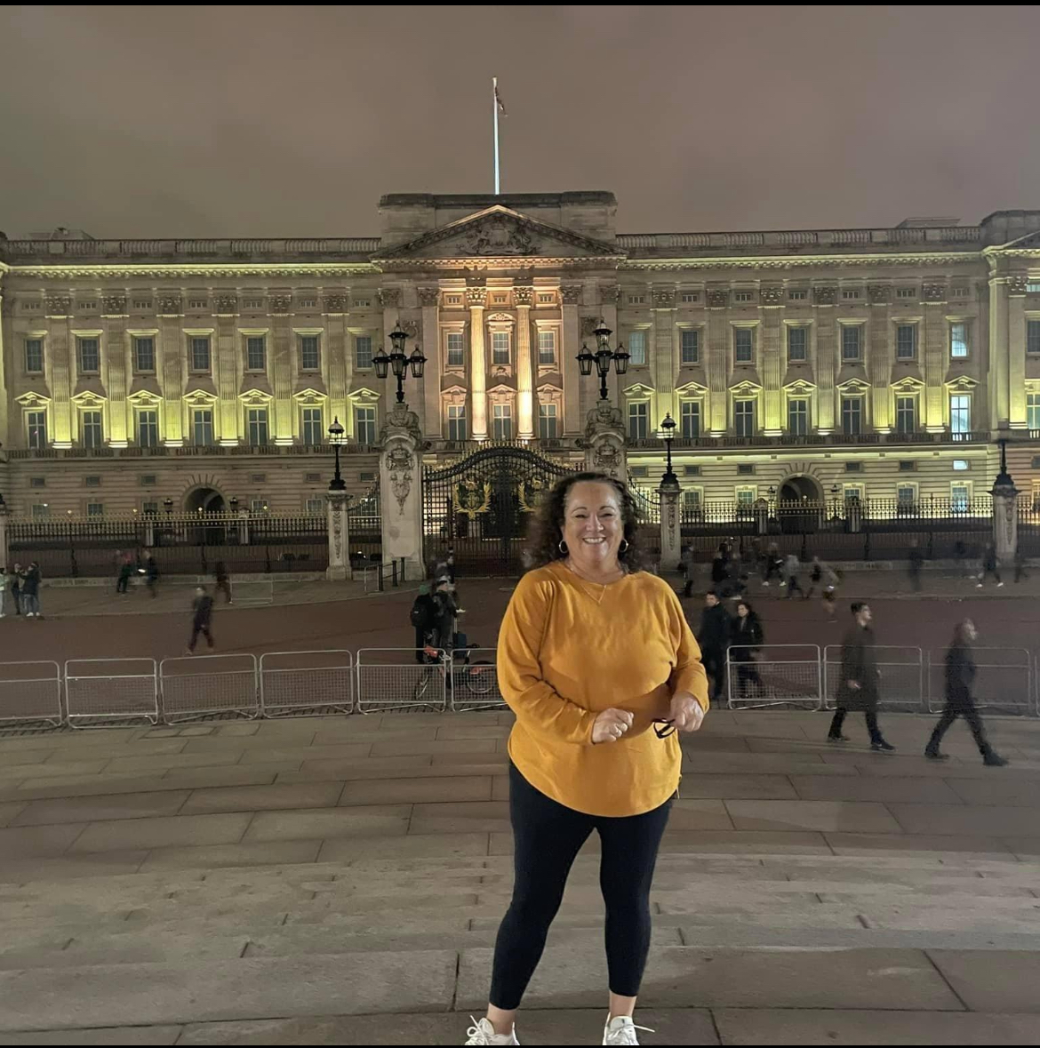 A photo of Kristen in front of Buckingham Palace.