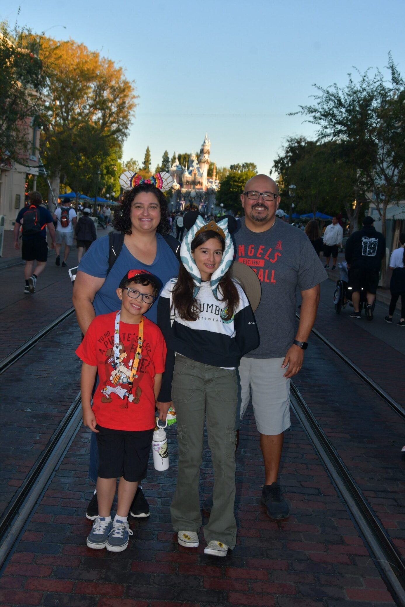 A photo of Lynn Marie, her husband, and two children at Disneyland.