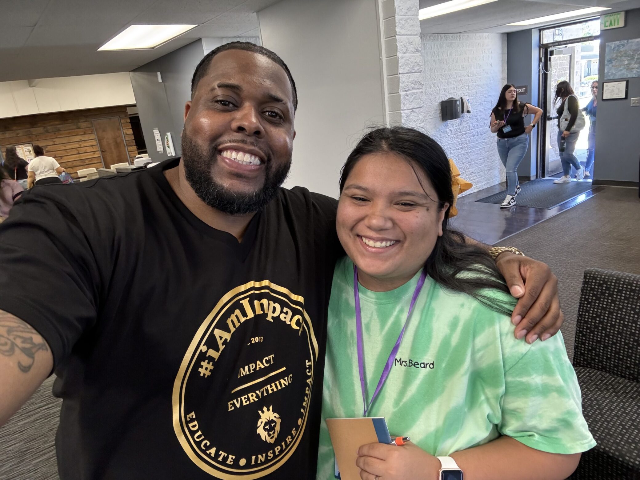 A photo of Nathan and a staff member, smiling.