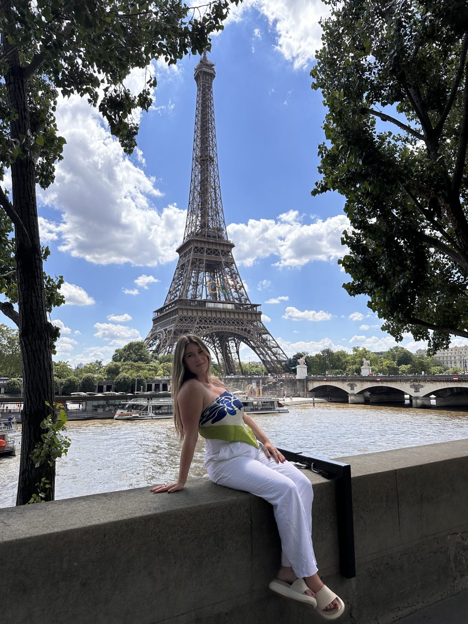 A photo of Nicolette in front of the Eiffel Tower in Paris.