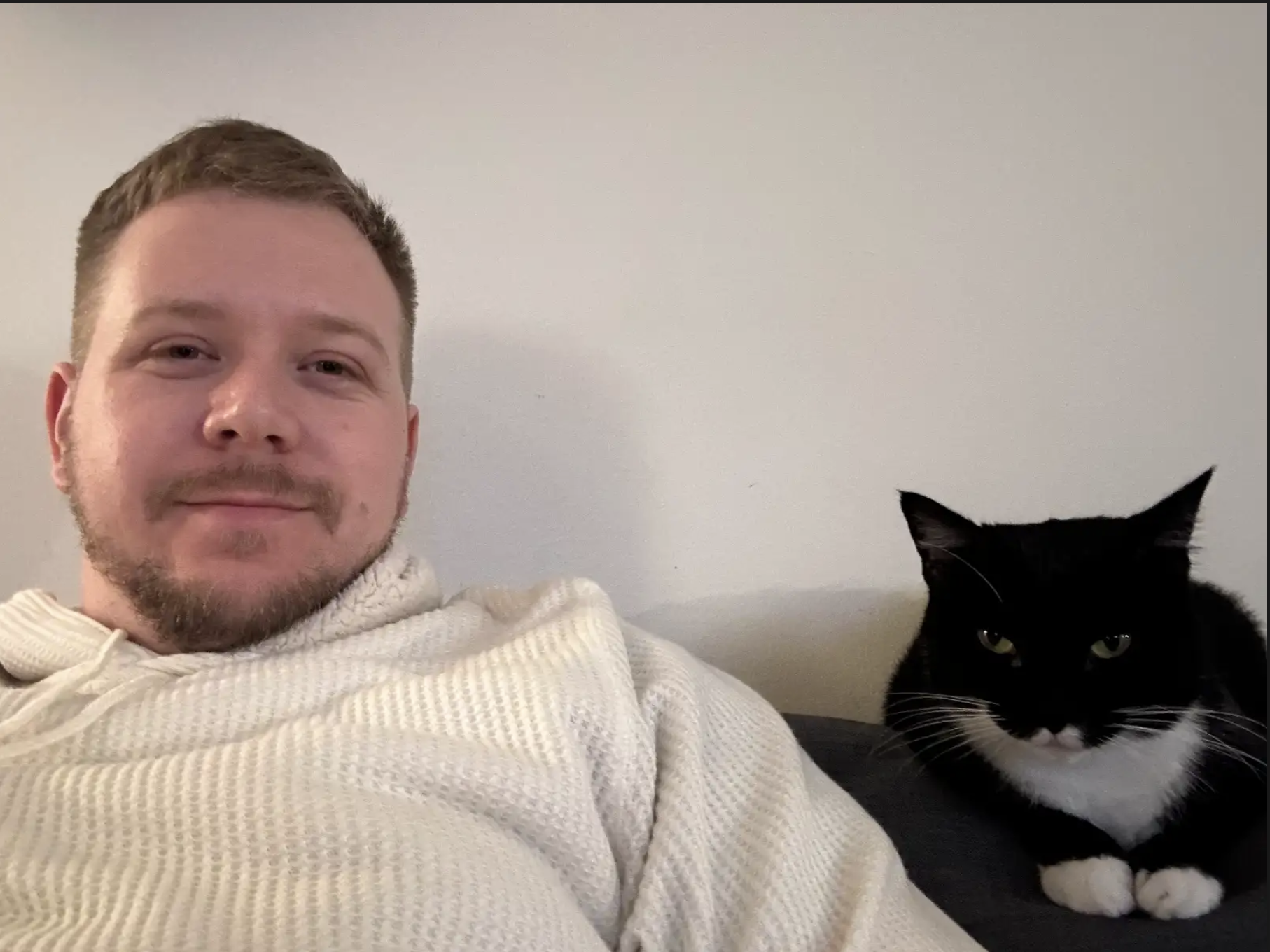 A photo of Connor and his black and white cat named Fifi.